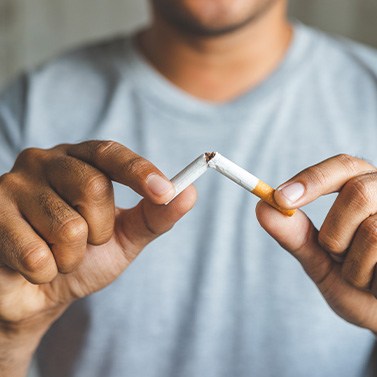Closeup of patient breaking cigarette
