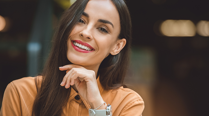 Woman in light orange shirt smiling