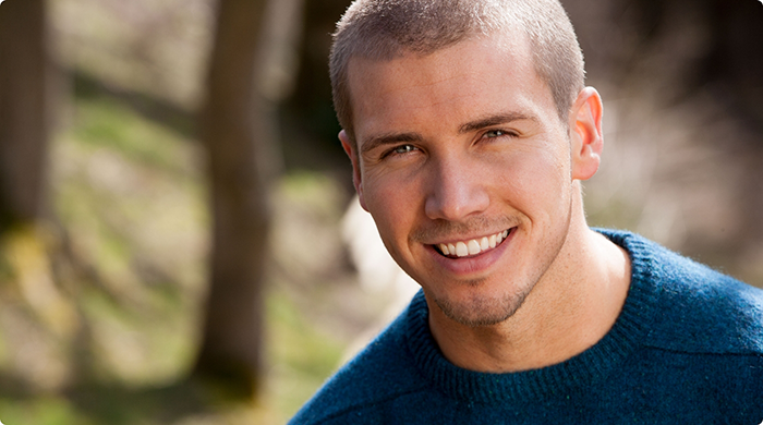 Man in blue sweater smiling