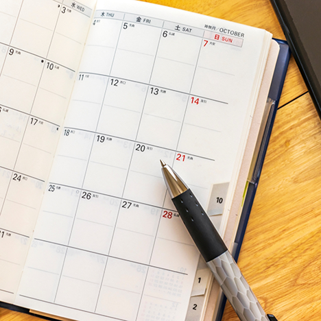 Day planner with pen lying on top