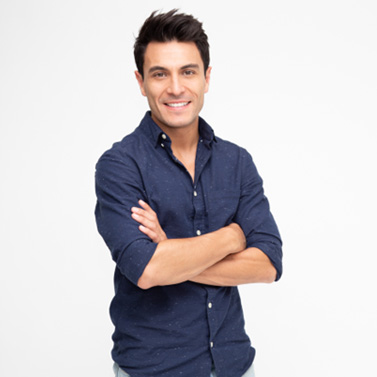 Confident, smiling man standing against neutral background