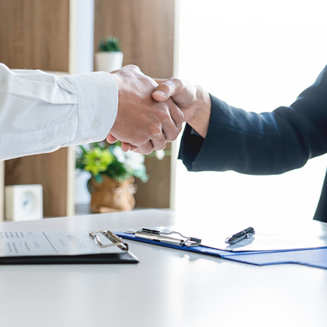 Dentist and patient shaking hands
