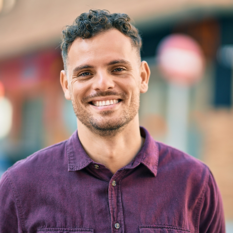 Man in purple shirt smiling
