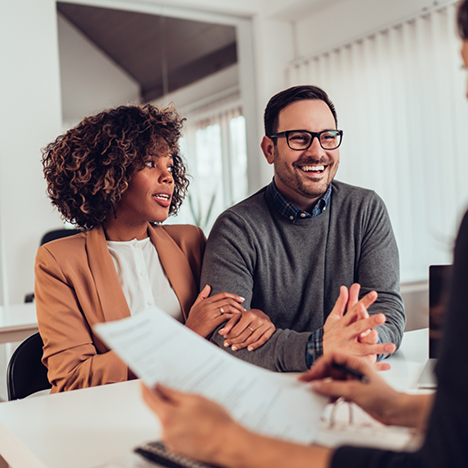 Woman and man talking to someone with form