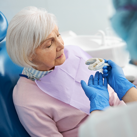 Senior woman having impressions taken for dentures