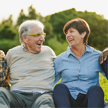 Man and woman sitting in circle laughing