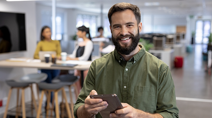 Smiling man with beard and green button-up shirt