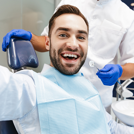 Bearded man smiling during his dental checkup