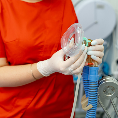 Dental team member holding mask for nitrous oxide sedation