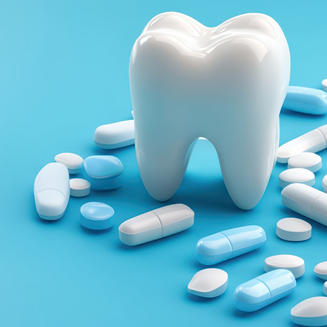 Model of tooth surrounded by pills