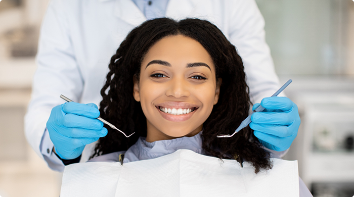Female dental patient smiling during dental checkup