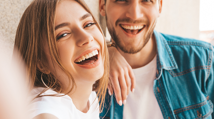 Blonde woman and bearded man laughing