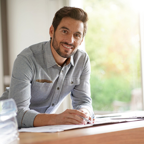 Man in button-up shirt smiling