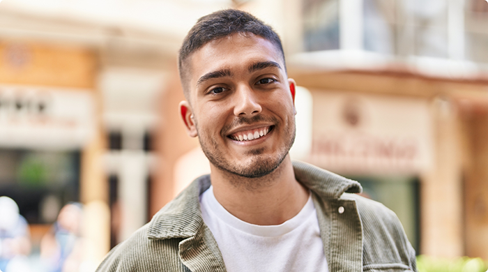 Man in jacket smiling outside