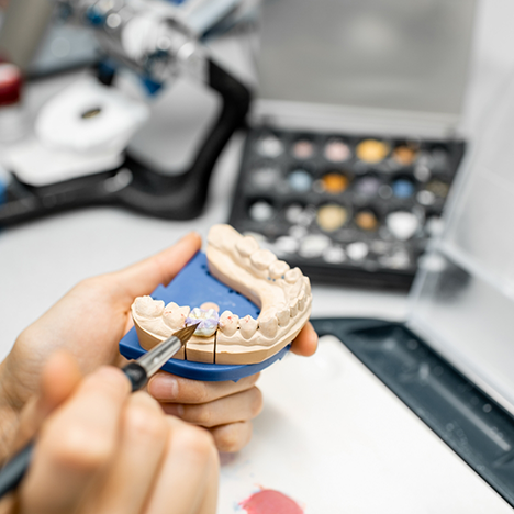 Working on replacement teeth in dental laboratory