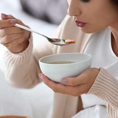 A woman having a bowl of soup