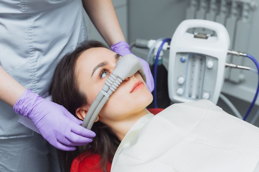 A woman getting nitrous oxide treatment at the dentist.